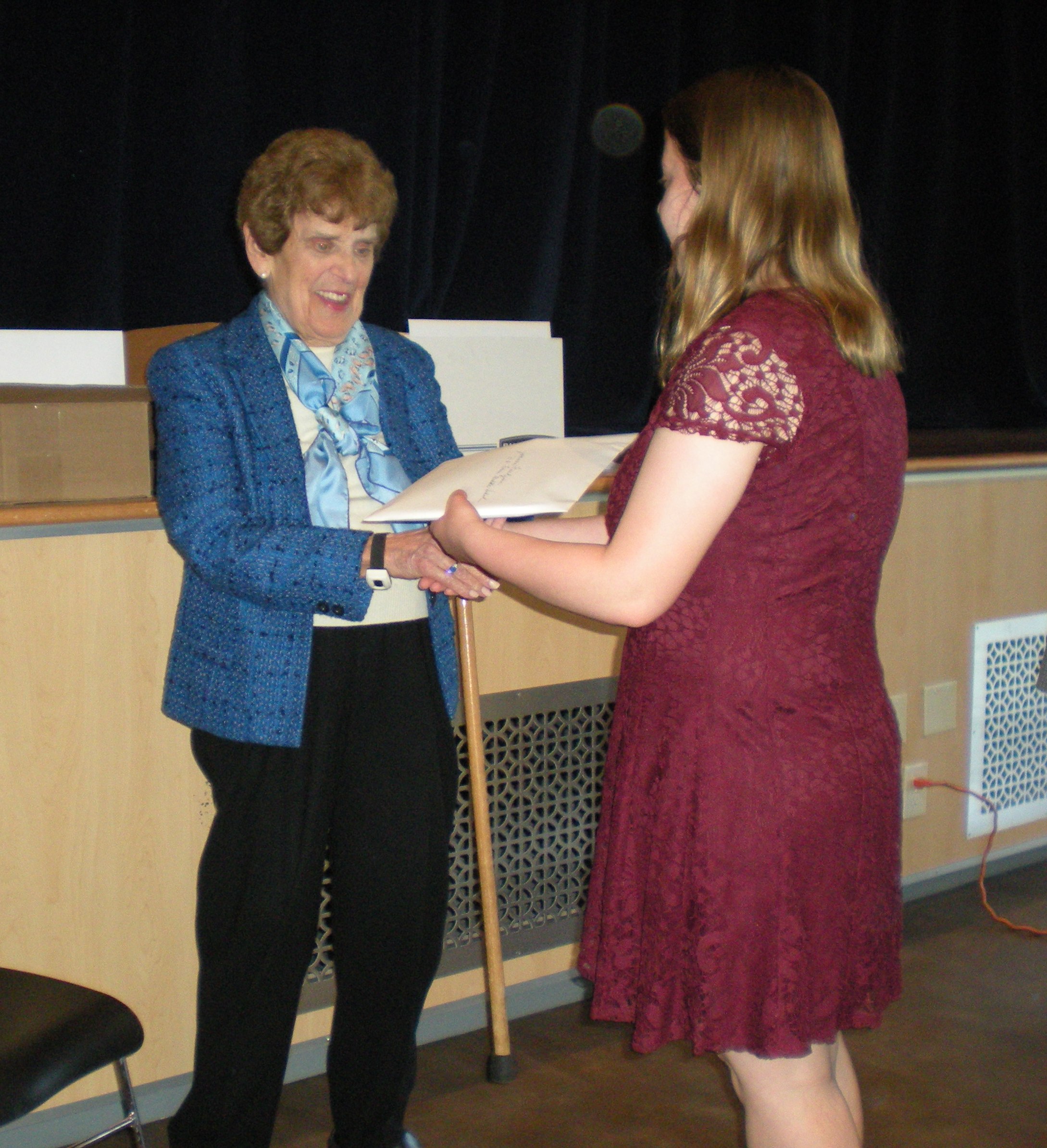 Art award being handed to a student recipient. 